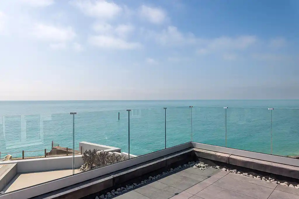 Uninterrupted ocean views from the glass-fronted balcony at Selsey Beach House.
